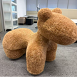 Brown fuzzy chair shaped like a horse in an office setting