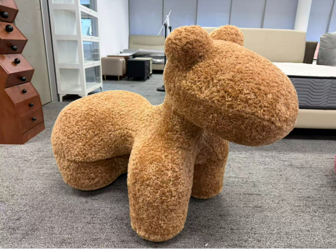 Brown fuzzy chair shaped like a horse in an office setting