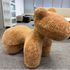Brown fuzzy chair shaped like a horse in an office setting