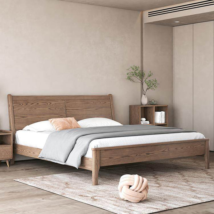 Wooden bed in a bedroom with neutral decor