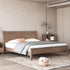 Wooden bed in a bedroom with neutral decor