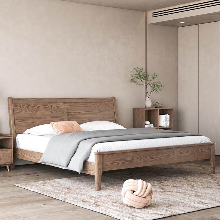 Wooden bed in a bedroom with neutral decor