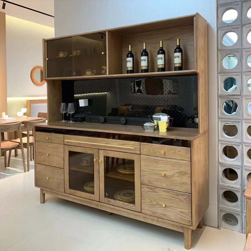 Wooden entertainment console with glass doors and wine bottles in a modern living room.