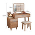 Wooden vanity table with illuminated mirror, drawers, and small stool
