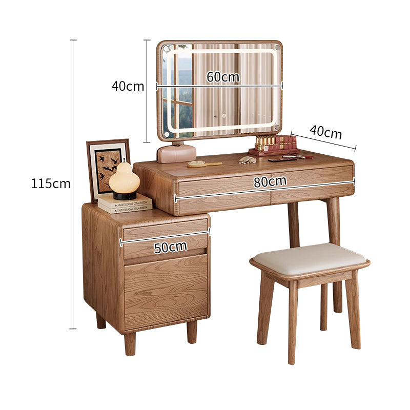 Wooden vanity table with illuminated mirror, drawers, and small stool