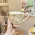 Handled teacup with rabbit illustration and cream spoon