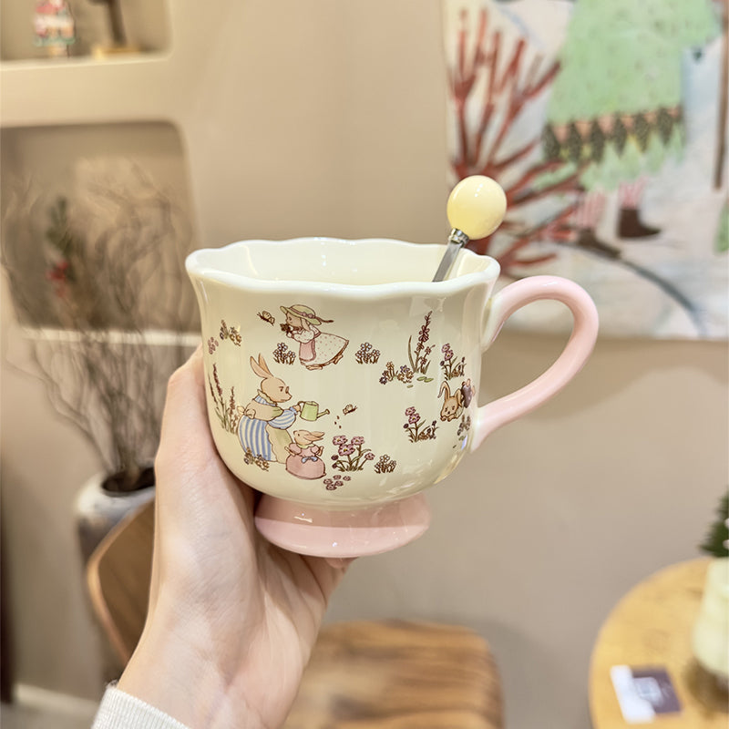 Handled teacup with rabbit illustration and cream spoon
