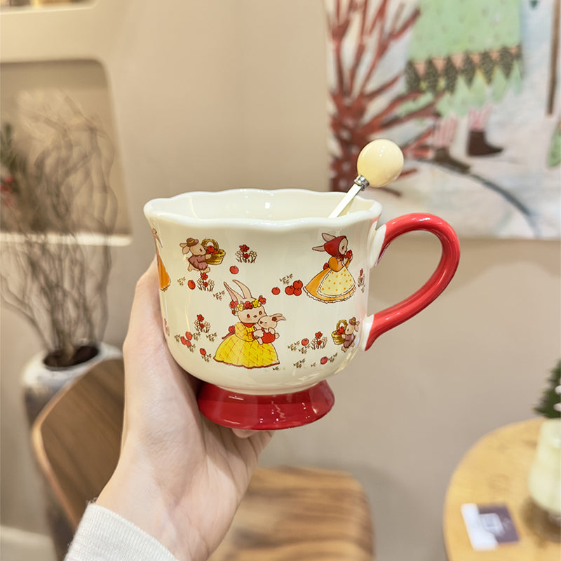 Handled teacup with rabbit illustration and cream spoon