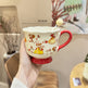 Handled teacup with rabbit illustration and cream spoon