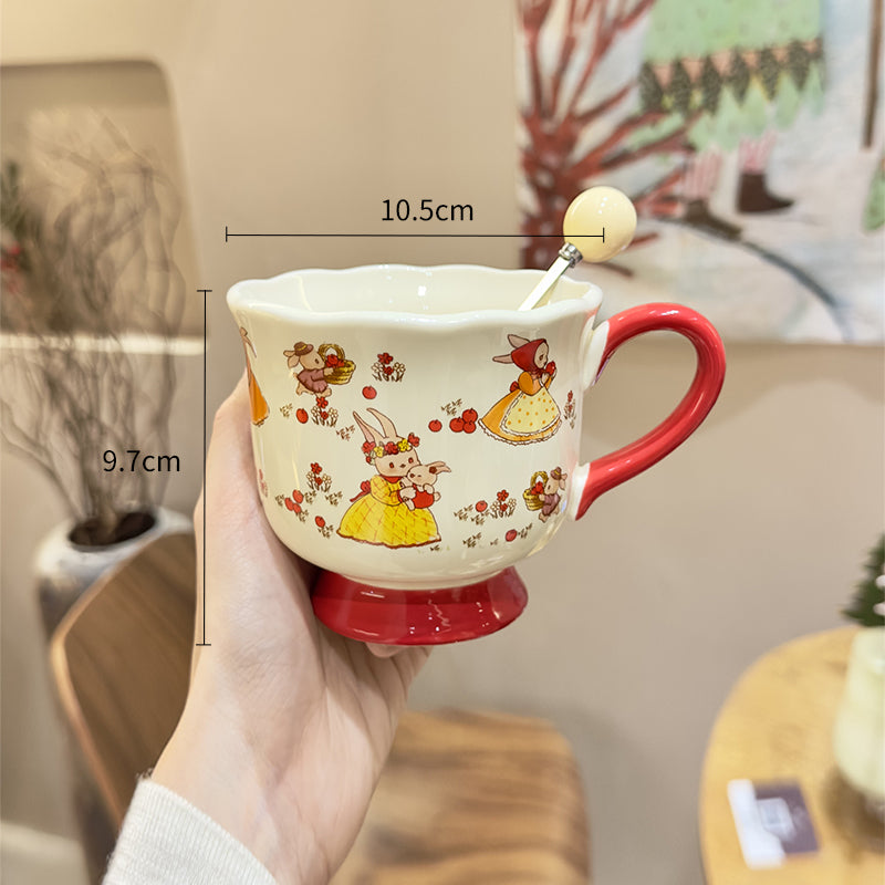 Handled teacup with rabbit illustration and cream spoon